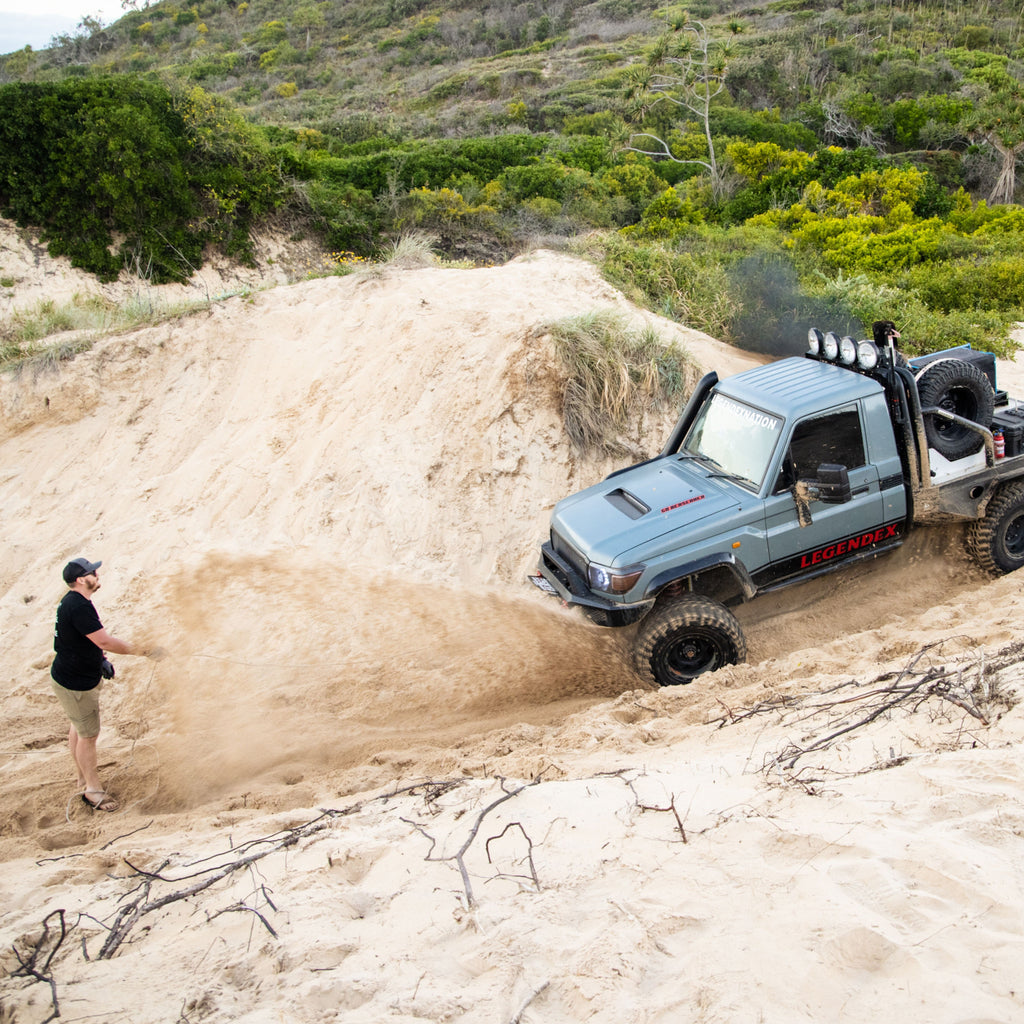 Car bogged in sand spinning wheels